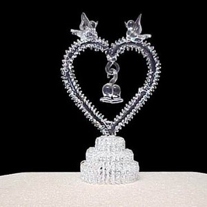 Small spun glass heart wedding cake topper.