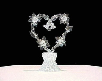 Roses wedding cake topper with four roses on a heart.
