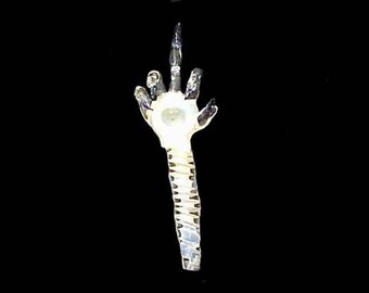 Hand blown glass middle finger skeleton pipe.