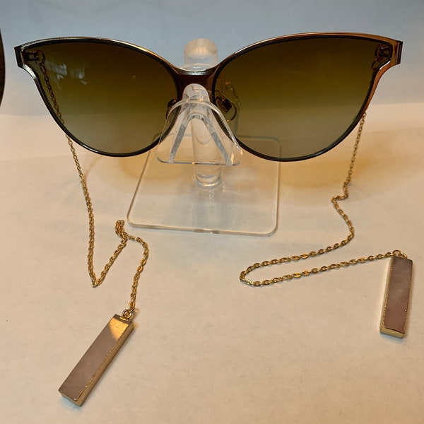 Armless sunglasses with rose quartz pendants and gold details
