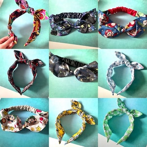 May include: Nine different fabric headbands with a knotted bow design. The headbands feature various patterns including a black and white space pattern, a blue and red Mario pattern, a green and white pattern, a yellow and white pattern, and a white and black pattern.