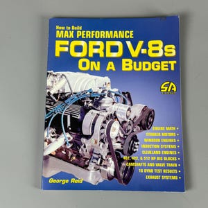 May include: A blue book cover with the title "How to Build Max Performance Ford V-8s on a Budget" and a photo of a Ford V-8 engine. The book is published by SA Designs.