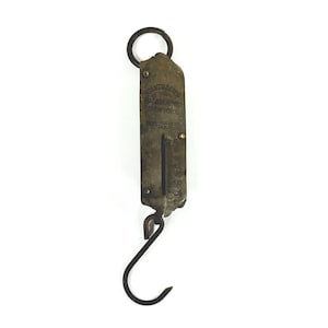May include: Vintage brass hanging scale with a curved hook and a ring at the top. The scale has a measurement gauge and the text "CHATTILLON'S BALANCE NO. 2 NEW YORK". Designed for weighing items.