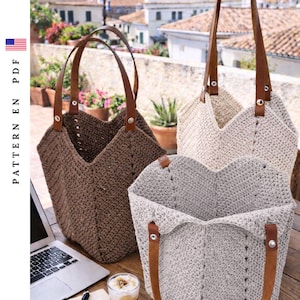 May include: Three crochet tote bags in shades of brown, beige, and gray with brown leather handles. The bags are open, revealing their interior. The bags are on a wooden table with a laptop and a cup of coffee.