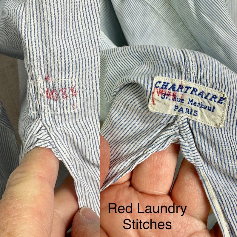 Pu&ograve; includere: Primo piano di una camicia a righe blu e bianche con cuciture rosse. La camicia ha un'etichetta che recita "CHARTRAIRE 37, Rue Marbeuf PARIS".