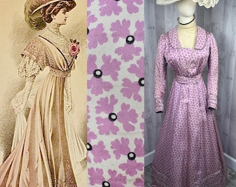 May include: A vintage dress with a floral print in shades of pink and white. The dress has a fitted bodice and a full skirt. The dress is shown on a mannequin wearing a hat with feathers and lace.