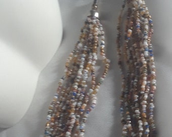 A multistranded seed beaded necklace with soft colors.