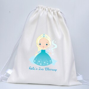 May include: White cotton drawstring bag featuring a printed image of a cartoon princess in a blue dress and crown. The text "Ariel's 2nd Birthday" is printed below the image.
