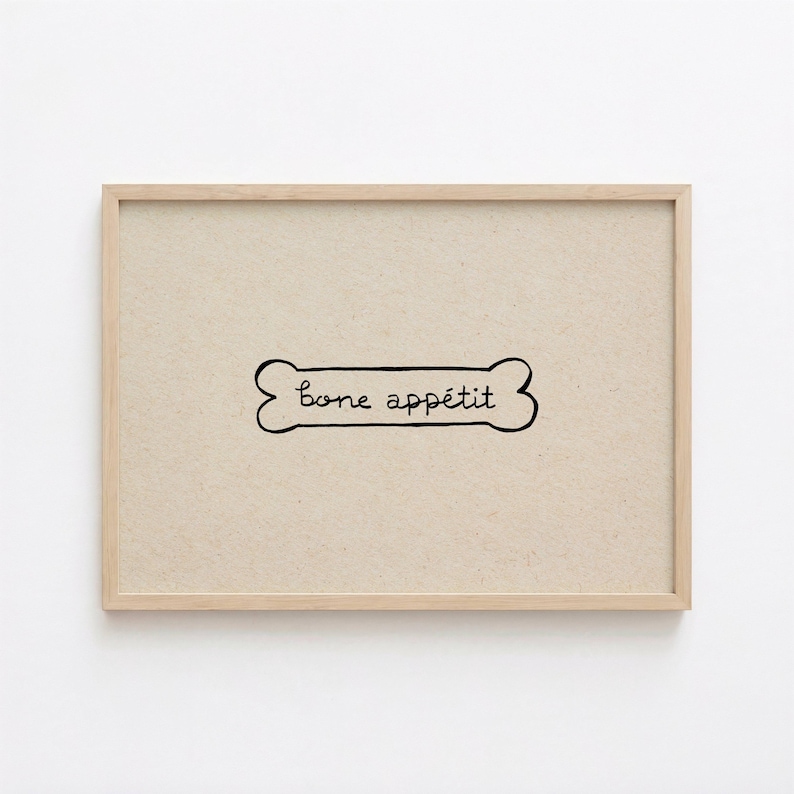 May include: A framed print featuring a dog bone illustration with the words "bone app&eacute;tit" in a handwritten style. The artwork is set against a beige background and framed in a light wood frame.