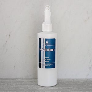 May include: White bottle with a blue label that says "Kaidan" and "Ocozo, Palo Santo, Amber" with a white spray nozzle. The bottle is labeled as a "Natural Room Spray" and is made in Indiana.