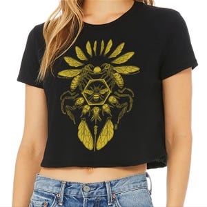 May include: A black cropped t-shirt with a yellow graphic design of a bee and honeycomb surrounded by bees and wings.
