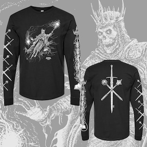 May include: Black long-sleeve t-shirt with a white graphic print of a skeletal figure wearing a crown and holding a staff. The back of the shirt features a white graphic print of a sword and two other weapons.