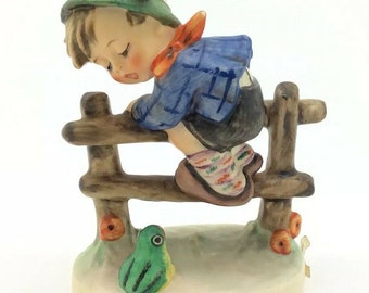 hummel boy on fence with frog