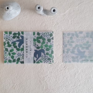May include: Two notecards with a nature theme. One card features a green and blue leaf and bird pattern with Japanese text. The other card has a similar leaf pattern with lined spaces for writing and the text "ton to san".