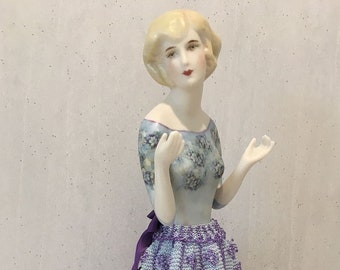 Half doll "Adelaide" featured as figurine in blue and purple