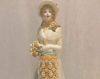 A beautiful ceramic reproduction of "Marianne"  approx 9.5" long beaded skirt.