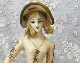Porcelain half doll "Eloise" with hat painted in pale pink and trimmed with decals and gold