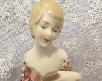 Antique half doll "Gabriella" approx 11cms cms painted in pink with decals and gold trim.  She carries a mirror and lipstick.