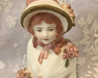 Reproduction ceramic half doll "Marianne" 10.5 painted in cream and deep pink.