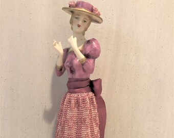 Half doll Gabriella with boater hat painted in pink with decals and porcelain flowers on her hat.