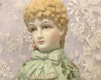 This half doll "Adelle" 13 cms tall was made from a statue and arms added - painted in green with decals