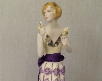 Porcelain half doll "Adelaide" painted in cream with decals and handmade porcelain flowers on her bodice in long beaded skirt.