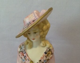 Antique reproduction half doll "Donna" approx 9 cms tall painted in pink and decorated in decals with gold trim