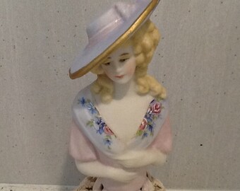 Antique reproduction half doll  "Donna" approx 9 cms tall painted in pink and blue with gold trim and decals.