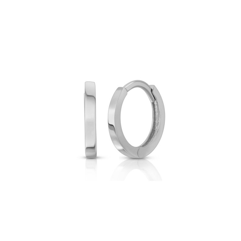 May include: Two silver-colored hoop earrings. One earring is open, displaying the clasp, while the other is closed. The earrings have a flat, rectangular design and a polished finish. The background is white.