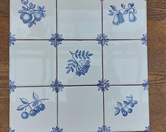 70 hand painted Delft style ceramic tiles: Blue orchard. 20 fruit and 50 corner tiles/butterfly.