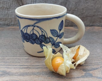 Handmade pottery creamy white ceramic mug with hand painted blue rowan