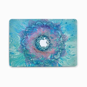 May include: A blue and purple mandala design laptop skin with a white apple logo in the center.