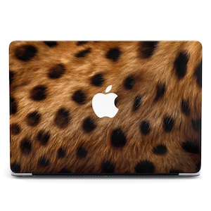 May include: A laptop skin with a brown and black leopard print design. The Apple logo is visible in the center of the skin.