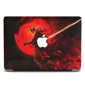 May include: Laptop skin featuring a dark fantasy illustration. A red-robed figure with a crown and a glowing sword is set against a red, fiery background. The Apple logo is visible on the laptop.