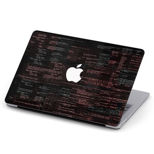 May include: A black laptop with a white Apple logo on the lid. The lid is covered in a design of pink and black code.