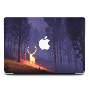 May include: A laptop case featuring a forest scene with a glowing deer. The design has a dark, moody color palette with shades of purple, blue, and orange. The Apple logo is visible on the case.