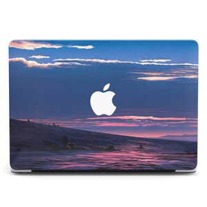 May include: A laptop skin with a sunset over the ocean and a silhouette of a person surfing. The skin features a white Apple logo.