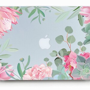 May include: A light blue laptop skin with a floral design featuring pink flowers and green leaves. The Apple logo is visible in the center of the skin.