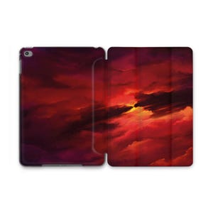May include: An open tablet case featuring a vibrant, abstract painting of a sunset. The artwork showcases a dramatic sky with shades of red, orange, and yellow, creating a fiery and dynamic visual. The case is designed to protect the tablet while displaying the artwork.