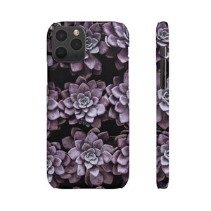May include: Purple succulent phone case with a repeating pattern of succulents. The case has a cutout for the camera lens.