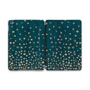May include: Teal iPad case with a gold polka dot pattern. The case is open, revealing the interior and the device. The design features a dark teal background with scattered gold dots, creating a stylish and modern look. The case is designed to protect the iPad.