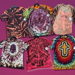 May include: Six tie-dye T-shirts in a variety of colours and patterns, including black, orange, red, green, blue, and yellow. The shirts are all made of cotton and have a relaxed fit.