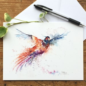 May include: Watercolor painting of a pheasant in flight with a colorful, splatter-like background. The pheasant is painted in shades of orange, red, purple, and blue.