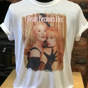 Death Becomes Her - White T-Shirt. Men's & Women's all sizes