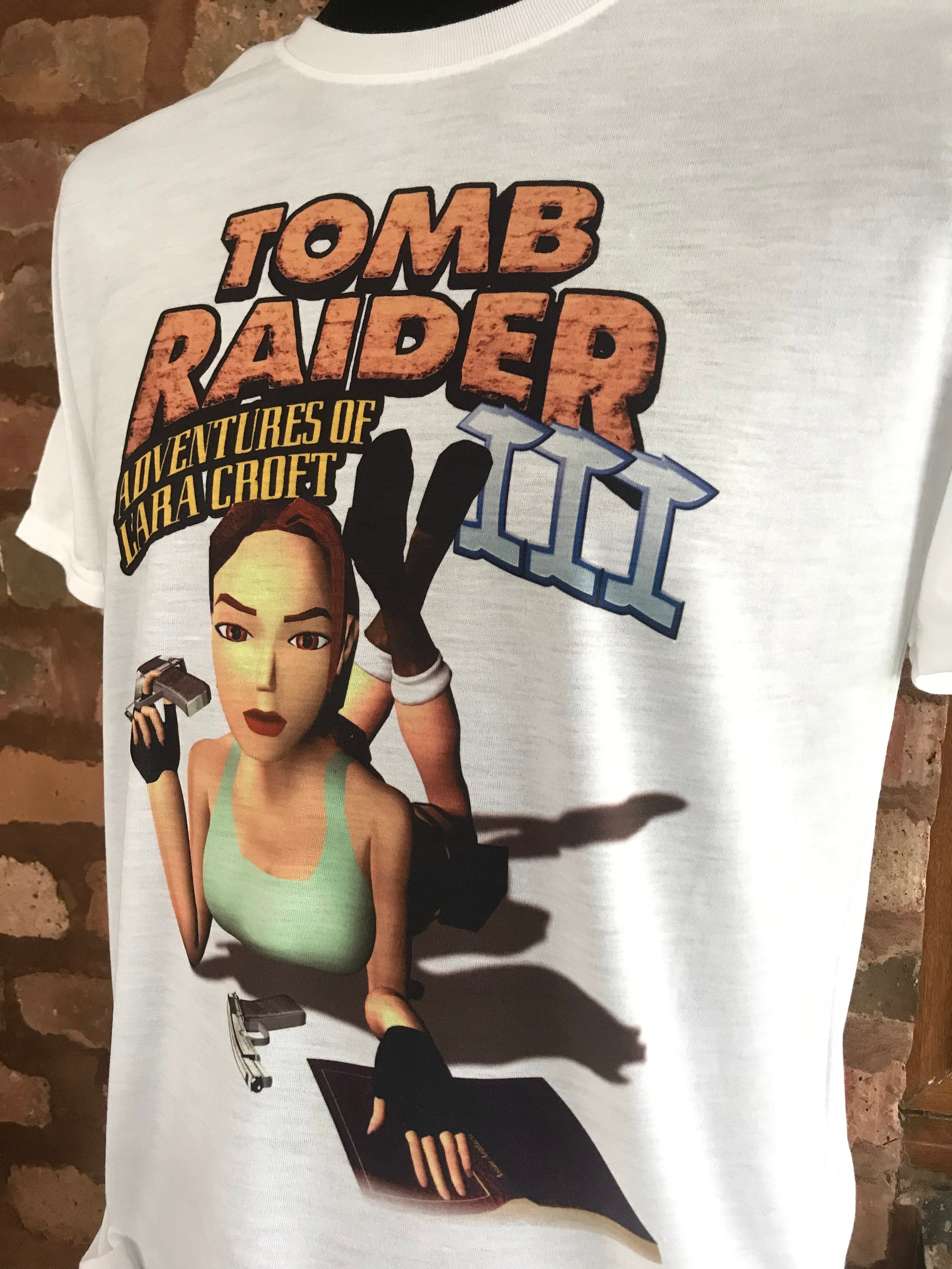 トゥームレイダー 3 - ララ クロフトの冒険 - 白い T シャツ。90 トゥームレイダー 3 - ララ クロフトの冒険 - 白い T シャツ。90