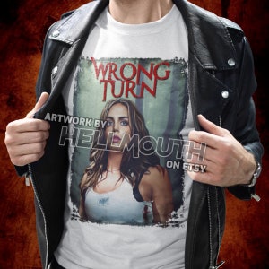 May include: White t-shirt with a graphic print of a woman from the movie "Wrong Turn". The graphic is in a distressed style with the title "Wrong Turn" in red.