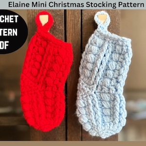 May include: Two mini Christmas stockings, one red and one light blue, are displayed. The stockings are crocheted with a textured pattern. The image includes the text "Elaine Mini Christmas Stocking Pattern" and "CROCHET PATTERN PDF".