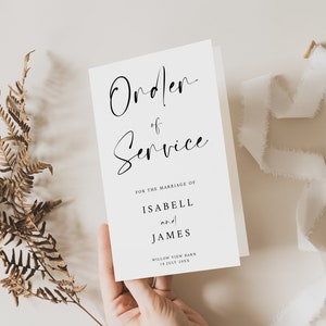 Puede incluir: Una tarjeta blanca con caligrafía negra que dice "Orden de Servicio" para la boda de "Isabell y James" en "Willow View Barn 14 de julio de 20XX".