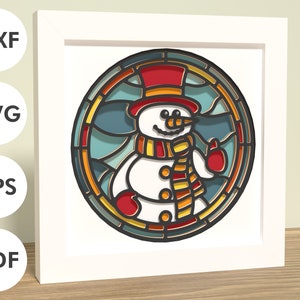 May include: A colorful stained glass style illustration of a snowman wearing a red hat, yellow scarf, and red mittens. The snowman is smiling and has a carrot nose.