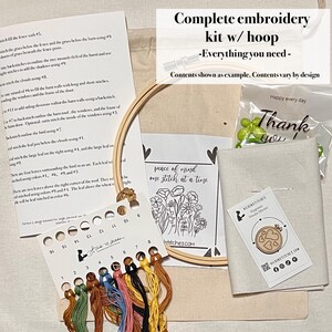 May include: A complete embroidery kit with a wooden hoop, embroidery floss in various colors, a needle, and fabric. The kit includes instructions and a small card that says "peace of mind one stitch at a time."